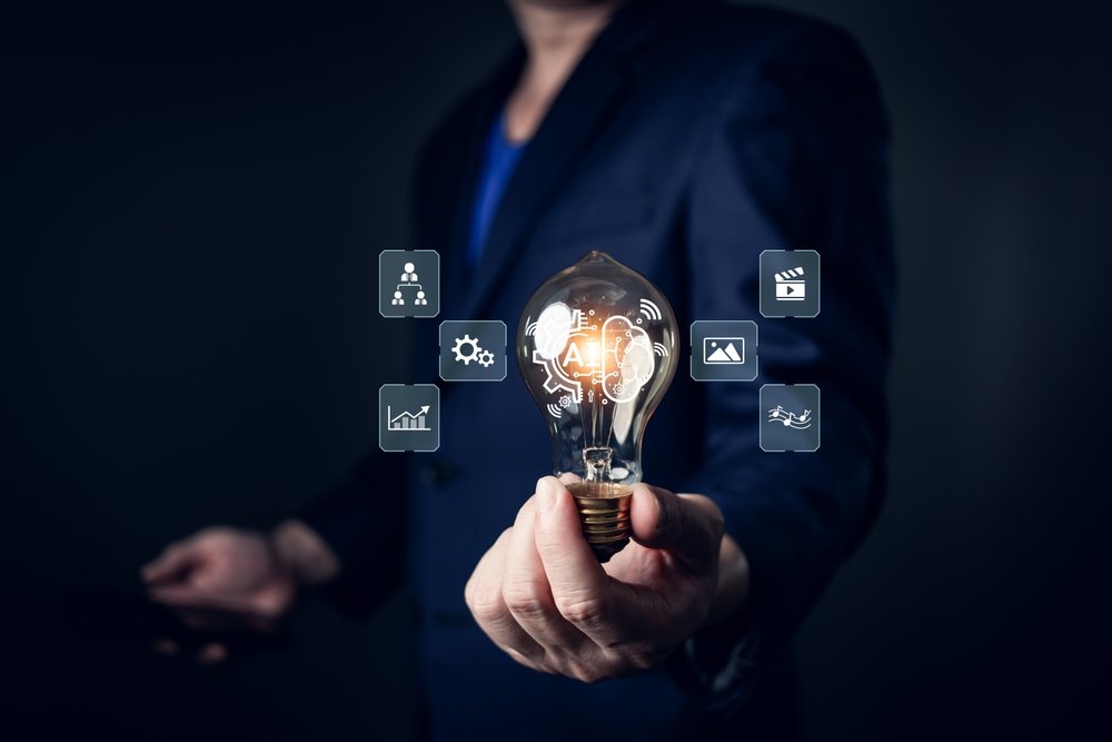 A,Person,In,A,Suit,Holds,A,Glowing,Lightbulb,Featuring